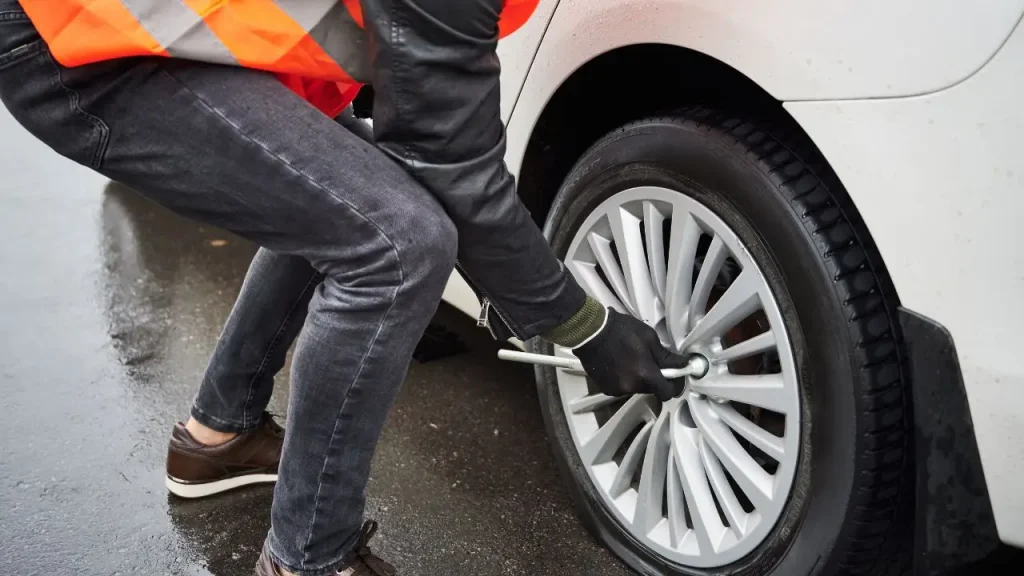 Towing professional loosening wheel lug nuts
